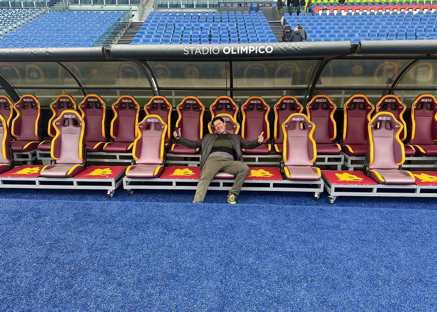 Touriste prenant la pose sur le banc des remplaçants du stade olympique de Rome